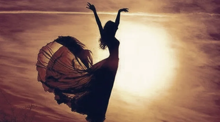 A dancer silhouetted against a glowing sunset